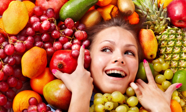 Woman with lots of fresh fruit